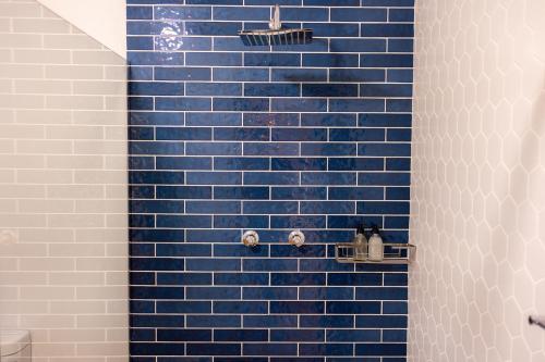 a blue tiled shower with blue tiles on the wall at Cape Robin Cabin at Vrolikheid Landgoed in Tulbagh