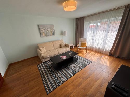 a living room with a couch and a table at Anna Apartment Timișoara in Timişoara