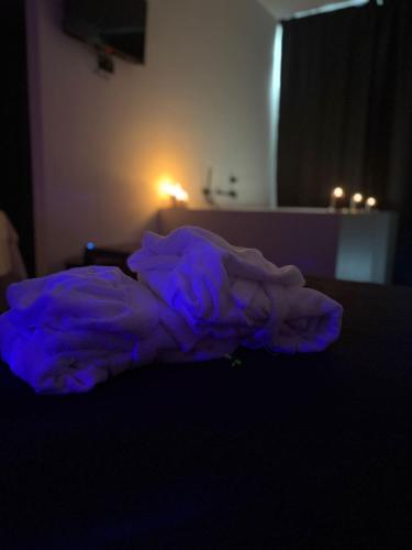 a purple blanket laying on a bed in a room at Panta Rei Camere di Charme e Spa in Taranto