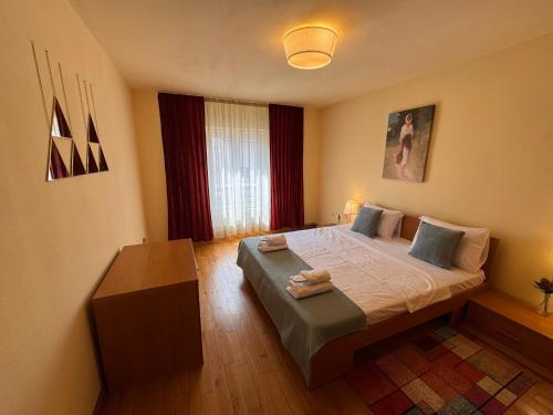 a bedroom with a bed with two towels on it at Anna Apartment Timișoara in Timişoara