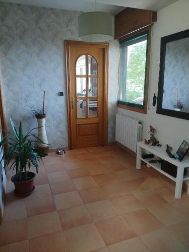 a living room with a door and a tile floor at Casa Paz in Nigrán