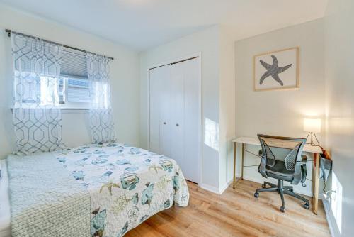 a bedroom with a bed and a desk and a chair at Charming Retreat in Ann Arbor in Ann Arbor