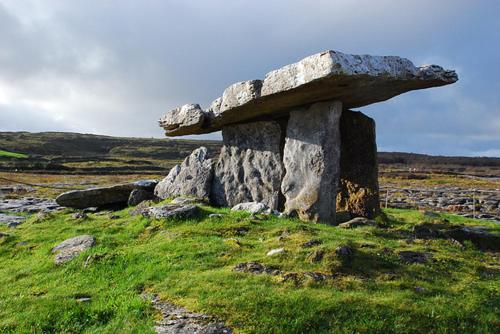 a stone bench sitting on top of a grassy hill at Cranagh House, Kinvara. in Loughcurra