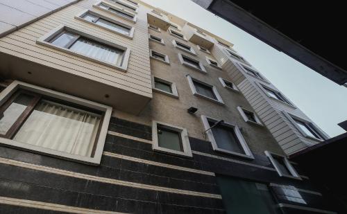 a tall building with windows on the side of it at Townhouse Hollywood Heights in Amritsar