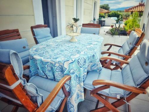 a blue and white table and chairs on a patio at Elia Apartment in Paralion astros