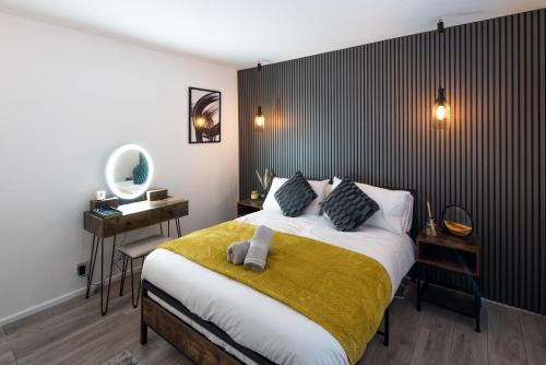 a bedroom with a bed and a desk with a mirror at 1 Bedroom apartment Kentish town in London