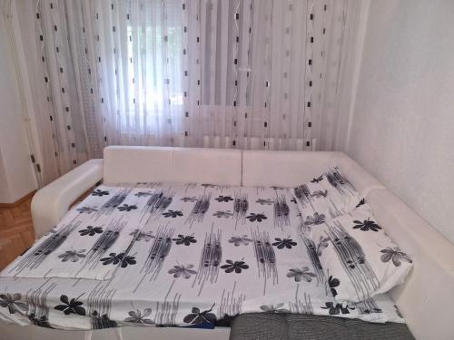 a bedroom with a bed with a bedspread with insects on it at Apartment V&S in Gevgelija