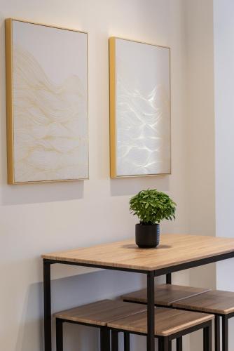 a table with a potted plant on top of it at Marea Luxury Suites in Koríthion