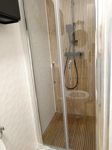 a shower with a glass door with a toilet at Zen aeroport in Sînnicoară