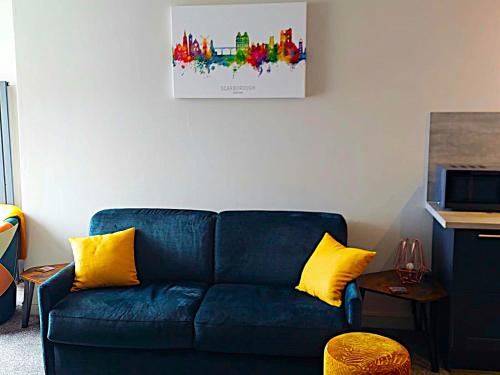 a blue couch with yellow pillows in a living room at 5 Prospect Place - 2nd floor Dream View in Scarborough