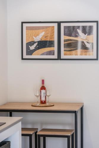 a table with two glasses and a bottle of wine at Marea Luxury Suites in Koríthion