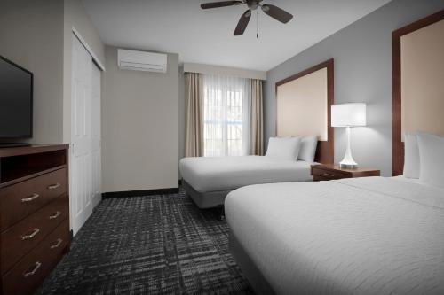 a hotel room with two beds and a flat screen tv at Homewood Suites by Hilton San Jose Airport-Silicon Valley in San Jose