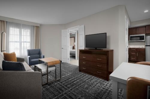 a hotel room with a television and a living room at Homewood Suites by Hilton San Jose Airport-Silicon Valley in San Jose