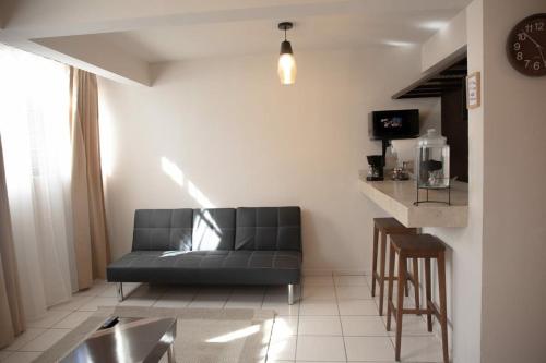 a living room with a couch and a table at Departamento Carrera in San José de Malpaso