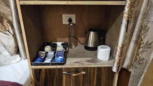 a small cabinet with a coffee maker and a blender at Kintsugi by Oztel in Kasol