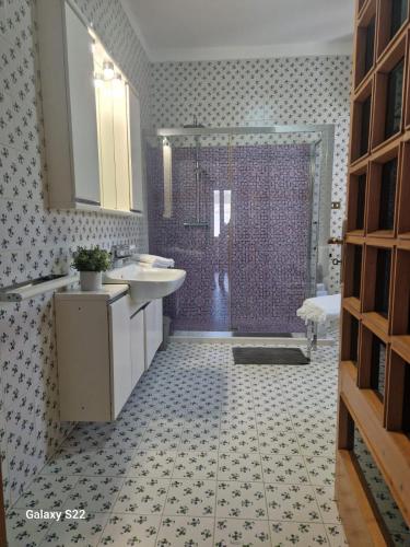 a bathroom with a shower and a sink and a tub at A Casa da Maria in Melissano