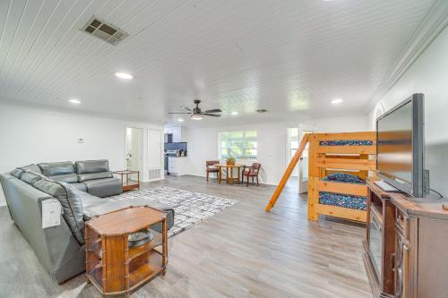 a living room with a couch and a table at Waterfront Lake Eufaula Home Dock and Beach Access! in Texanna