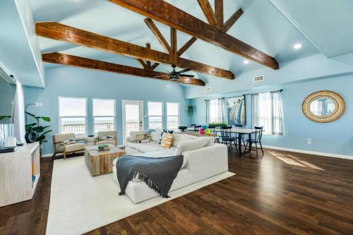 a living room with blue walls and wooden beams at Direct Beach Access Beachfront in Freeport