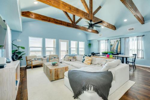 a living room with blue walls and a ceiling with wooden beams at Direct Beach Access Beachfront in Freeport