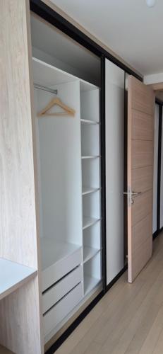 a walk in closet with a glass door at Skenderija Skyline Penthouse Sarajevo in Sarajevo