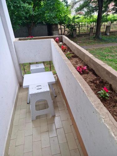a white picnic table and bench on a patio at Apartment V&S in Gevgelija