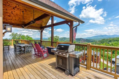 a grill on a deck with a table and chairs at Villa Tavia by Stony Brook Cabins in Gatlinburg