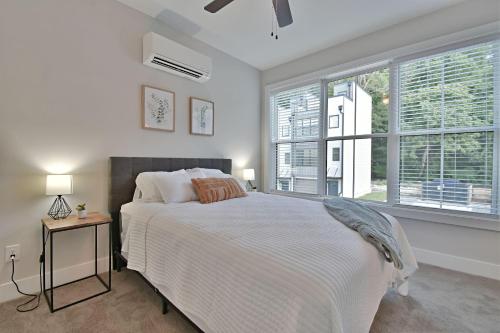 a white bedroom with a bed and a window at Island Home Retreat in Knoxville