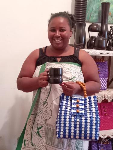 a woman taking a picture with a camera at Vivez comme nous chez nous in Sambava