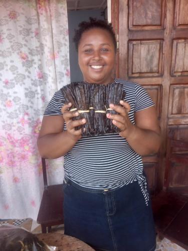 a woman holding a wine glass in her hands at Vivez comme nous chez nous in Sambava