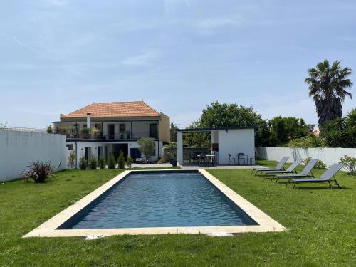 a swimming pool in the yard of a house at Casa Fonte Nova in Covões