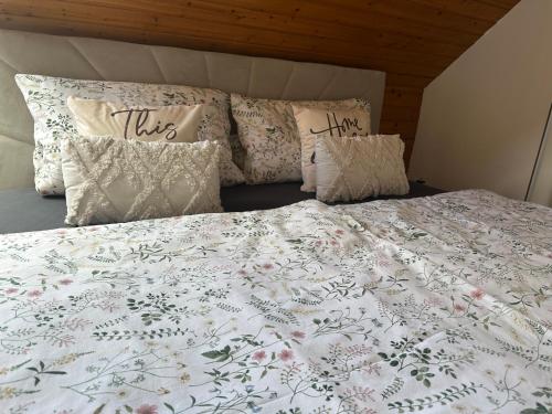 a bed with a white comforter and pillows at Blick auf den Rhein in Kestert
