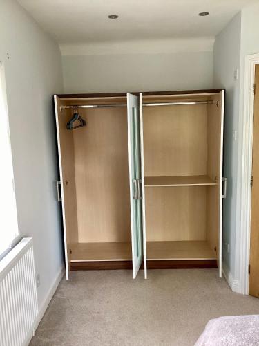a bedroom with two closets in a room at Lorton Villa with a Log Burner in Saint Helens