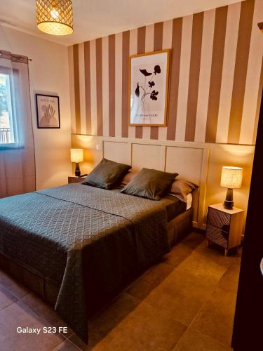 - une chambre avec un lit et un mur rayé dans l'établissement appartement T2 rive sud porticcio vue mer, à Pietrosella