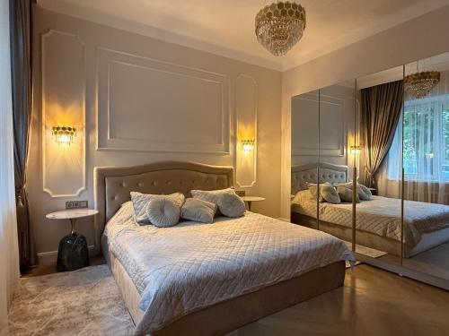 a bedroom with two beds and a mirror at KR Apartment Kaunas in Kaunas