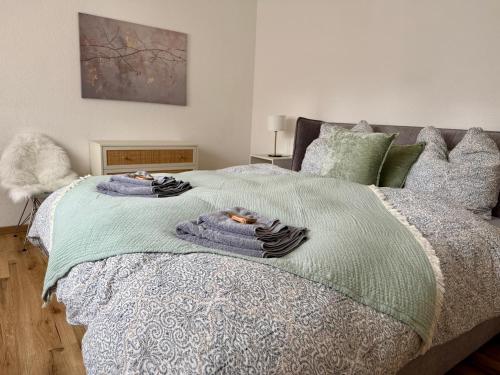 a bedroom with a bed with two towels on it at Bungalow no 9 in Dorsten