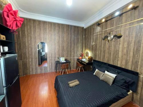 a bedroom with a blue bed and a desk at 17c dang van ngu 403 in Ho Chi Minh City