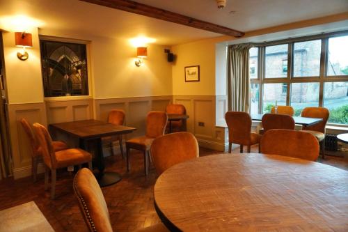 a dining room with tables and chairs and a window at The Angel Inn in Thirsk