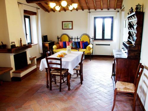 a dining room with a table and a living room at La Fornace di San Galgano in Chiusdino
