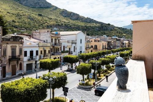 a city with a statue of a dog looking at a street at casa Fontana in Capaci