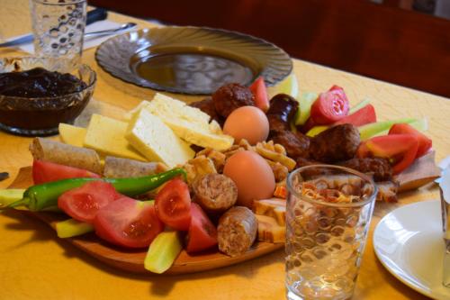 a plate of food with meat and vegetables on a table at Patakmenti Panzió Spa in Corund