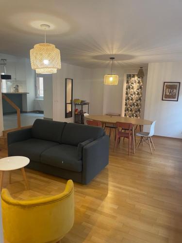 a living room with a couch and a table at LE PIERRE 2 CH 2 SDB 1 parking in Strasbourg
