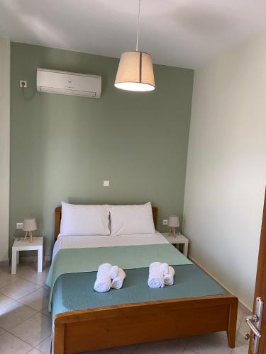 a bedroom with a bed with two towels on it at Rodia apartment in Kyparissia