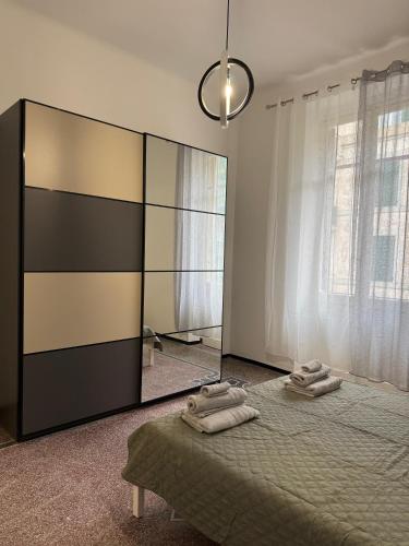 a bedroom with a bed with towels on it at Savona Casa Centro vicino Mare in Savona
