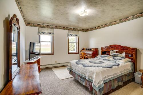 a bedroom with a bed and a table and window at Waterfront Lake Michigan Home on 15 Acres! in Manitowoc