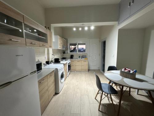 a kitchen with a table and a white appliance at Alios apartment in Rhodes Town