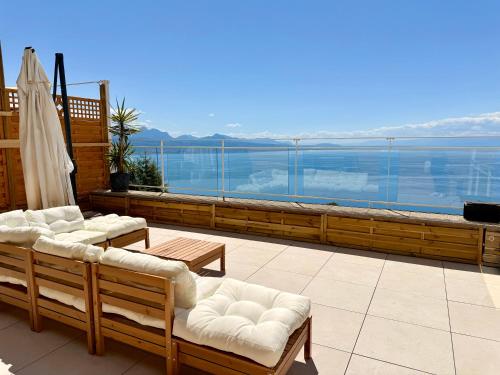 a balcony with chairs and a view of the water at Villa Lavaux in Grandvaux