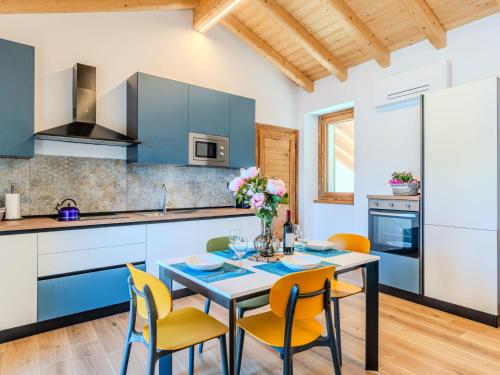 a kitchen with blue cabinets and a table with chairs at Apartment Svasso by Interhome in Verceia