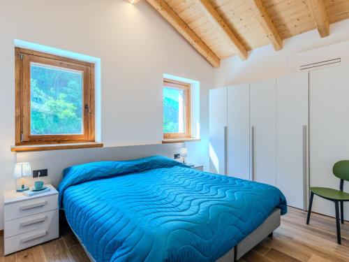 a bedroom with a bed and a desk and a chair at Apartment Svasso by Interhome in Verceia