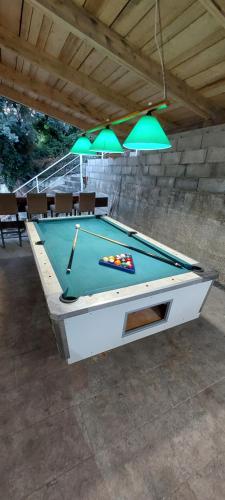 a pool table in a patio with green lights at Villa Hedonic in Ulcinj