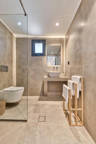 a bathroom with a tub and a sink at Marea Luxury Suites in Koríthion